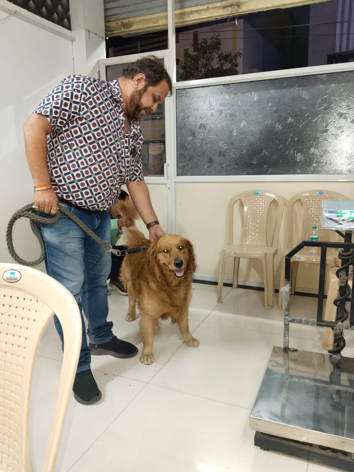 Pet parent with golden retriever at Happy Tails